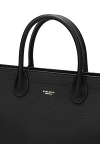 Black leather tote bag with textured finish, featuring dual rounded handles and a gold logo accent on the front.