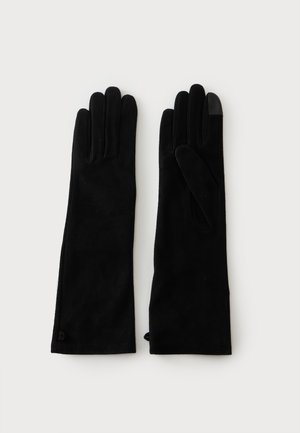 Paire de longs gants noirs avec un gant affichant un bout de doigt compatible avec un écran tactile sur fond blanc.