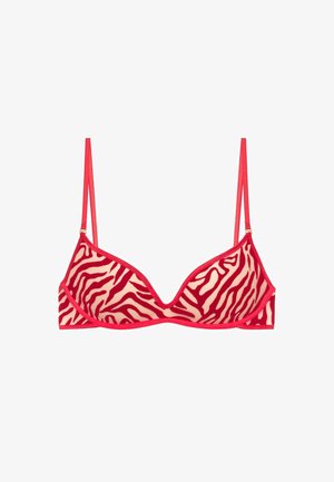 Punainen ja beige seeprakujuline rinnahoidja, millel on kolmnurkse kujuga tassid, õhukesed reguleeritavad rihmad ja sile tekstuur. Viimistletud ühtse punase värviga.