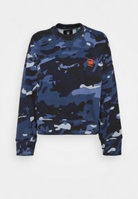 Blue and black camouflage long-sleeve sweatshirt with ribbed cuffs and a small orange "G RAW" logo on the left chest.