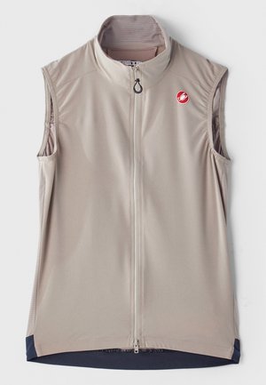 Chaleco sin mangas de color beige claro con cuello alto, cremallera frontal y detalles en azul marino en el dobladillo. Presenta un logo en el pecho. Tejido suave.