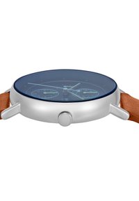Montre en métal argenté avec un cadran transparent bleu foncé, dotée de deux sous-cadrans et d'un bracelet en cuir orange. Forme circulaire et design épuré.