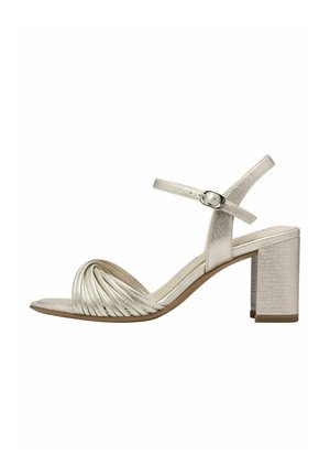 Sandale à talon haut argent métallique avec une bride avant nouée, un talon carré bloc et une bride de cheville réglable. Texture lisse dans l'ensemble.