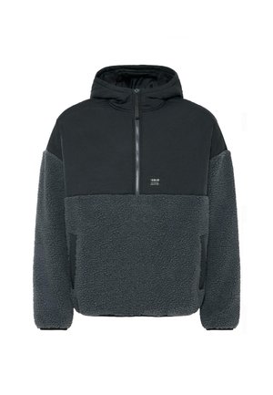 Hoodie en polaire gris foncé avec demi-zip à l'avant, corps et manches texturés, poitrine supérieure lisse et logo en patch à l'avant.