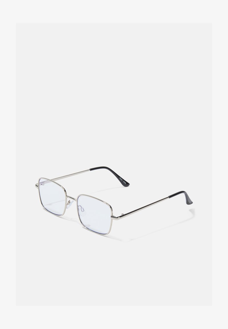 Ochelari cu ramă pătrată metalică, cu lentile clare și vârfuri negre contrastante pe brațe; design elegant și minimalist.