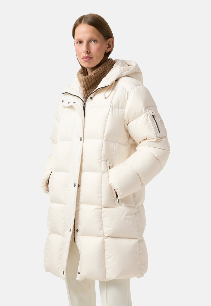 Padded cream-colored coat with a hood, featuring a zip front, two side pockets, and elasticized cuffs. Textured, warm knit collar.
