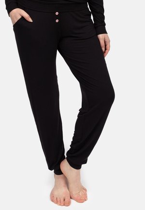 Schwarze Lounge-Hosen aus weichem Stoff, mit einer lockeren Passform, elastischem Bund und zwei rosa Knöpfen auf der Vorderseite.