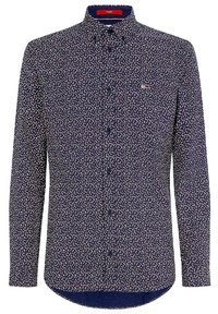 Camicia a maniche lunghe di colore blu navy con un piccolo motivo floreale. Presenta una chiusura con bottoni e un logo del marchio sul petto. Tessuto di cotone morbido.