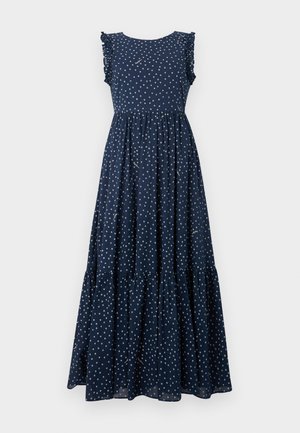Robe maxi bleu marine avec des pois blancs, des manches volantées, un corsage ajusté et une jupe à volants fluide. Fabriquée en tissu léger.