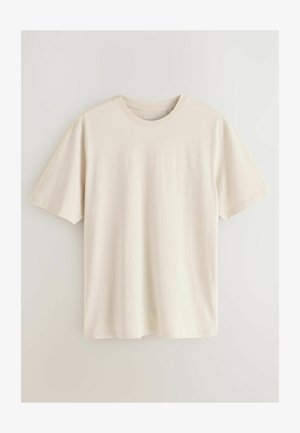 Light beige cotton t-shirt with short sleeves, round neckline, and a smooth texture. Simple design with no patterns or accents.
