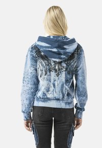 Blue hooded sweatshirt featuring a textured mural design with script accents, a soft finish, and a relaxed fit. Back view displayed.