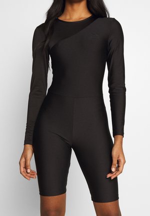 Sort langærmet bodysuit med tætsiddende pasform og cykelshorts. Fremstillet af et glat, elastisk materiale med et diskret logo.