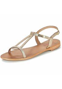 Platta sandaler med metalliska beige remmar, T-formad design och ett säkert vristband. Ljust brun sula med minimalistiska sömnadsdetaljer.