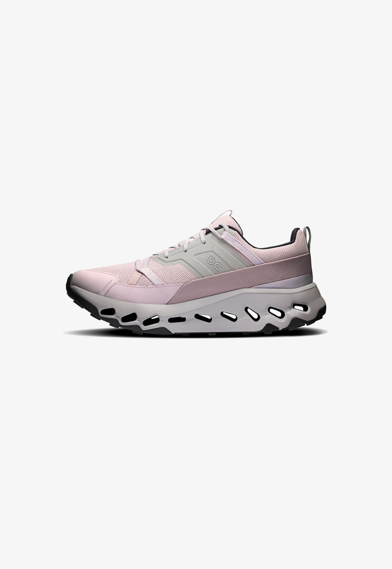 Light pink athletic shoe with mesh upper, gray accents, thick white midsole featuring ventilation holes, and black rubber outsole.