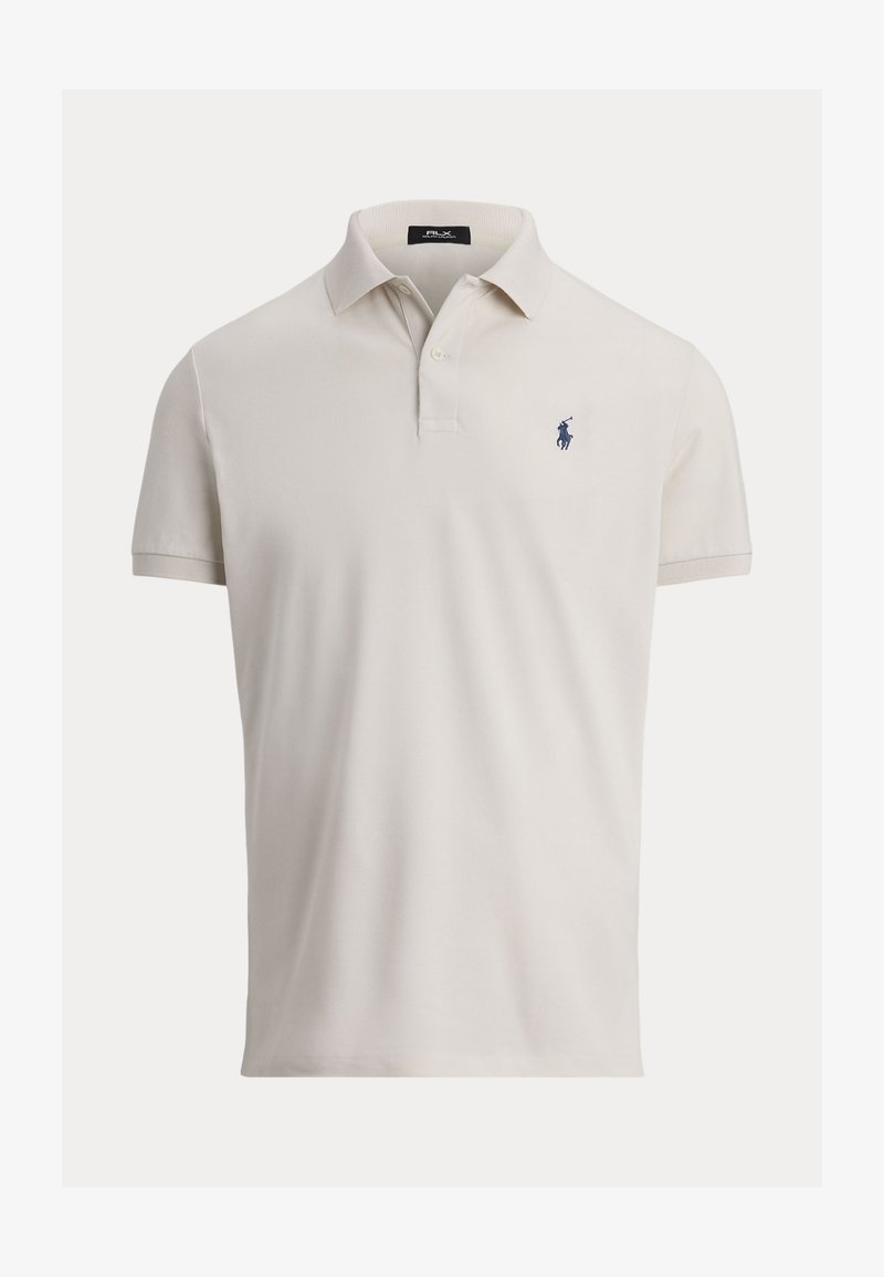 Polo en coton crème avec un col, des manches courtes et un petit logo marine sur la poitrine gauche. Texture lisse, coupe classique.