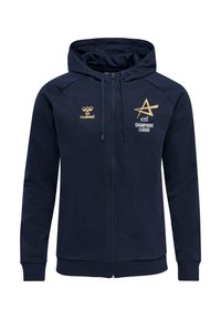 Marinblå zip-hoodie med snörning, med guldloggor: "hummel" och "EHF CHAMPIONS LEAGUE." Slät tyg och ribbade muddar.