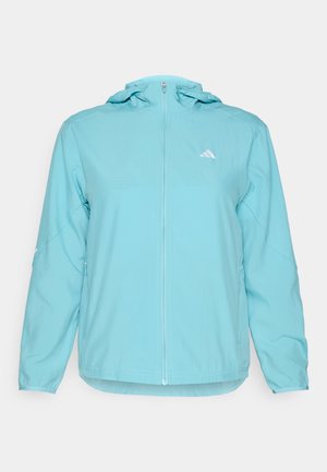 Veste à capuche bleu clair avec une fermeture éclair sur le devant, présentant un petit logo blanc sur la poitrine gauche et des poches latérales zippées.
