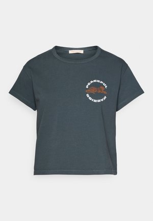 Dark gray cotton t-shirt with a round neckline, short sleeves, and a front graphic featuring a brown tiger and the text “Peaceful Warrior.”