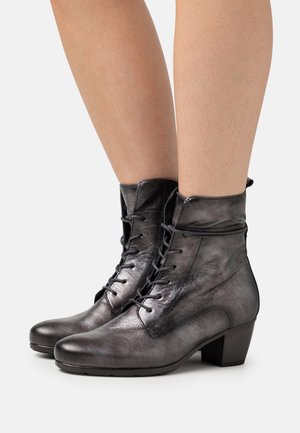 Metallic gray ankle boots with a smooth leather texture, lace-up front, and a low block heel for support. Features a folded collar detail.