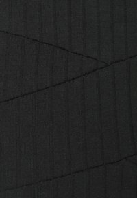 Tessuto di maglia nera con una texture a coste verticali di larghezze variabili e dettagli di cucitura diagonale che creano un aspetto stratificato.