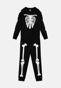 Black sweatshirt and pants set featuring white skeleton print. Sweatshirt displays ribcage and bones; elastic waistband on pants. Soft fabric.