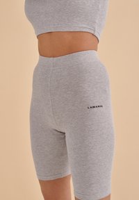 Gray ribbed bike shorts made of cotton blend material, featuring a high waistband and a small "LAMANIA" logo on the side.