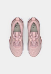 Light pink athletic shoes with mesh upper, laces, and cushioning. Features a rounded toe and contrasting rubber sole.