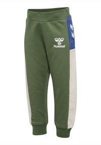 Olive green jogger pants with elastic cuffs, white side stripes, blue panels with white chevrons, and white Hummel logo on left thigh.