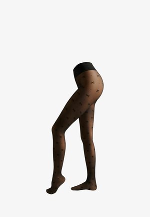 Zwarte gemusterde tights met kleine zwarte strikontwerpen, doorzichtig materiaal en een effen zwarte tailleband. Soepele textuur en een aansluitende pasvorm.
