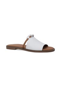 White leather slide sandals with a brown sole, featuring a diagonal cut and a decorative silver accent on the strap. Flat design and open toe.