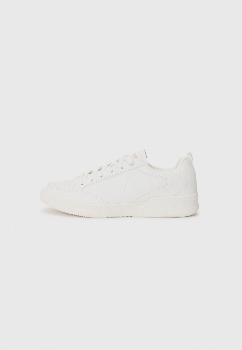 White athletic sneakers feature a smooth surface, round toe, and lace-up closure. Design includes subtle side detailing and textured rubber sole.