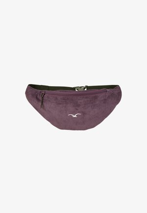Purple corduroy fanny pack with a curved shape, zippered front pocket, and an adjustable green strap. Features a white logo detail.