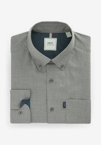 Folded grey button-up shirt with patterned dark blue inner collar and cuff lining, showing front buttons and a small fabric brand tag.