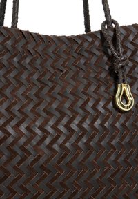 Brown woven leather tote bag with a textured pattern and braided handles; features a gold-tone hardware accent.