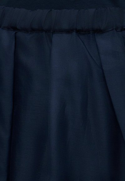 Σκούρο ναυτικό μπλε ύφασμα με ορατό συγκεντρωμένο ράμμα και ελαφριές ρυτίδες, που δείχνει υφή και απαλά πτυχώσεις.