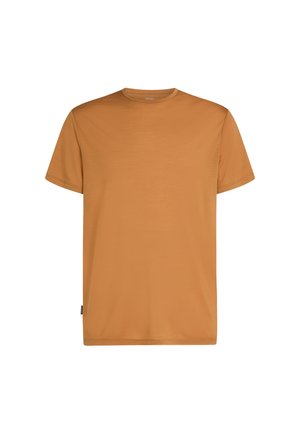 T-shirt a maniche corte con scollo rotondo di colore arancione bruciato uniforme, con una piccola etichetta nera in tessuto sulla cucitura laterale inferiore.