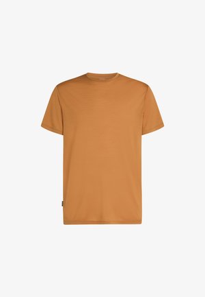 T-shirt a maniche corte con scollo rotondo di colore arancione bruciato uniforme, con una piccola etichetta nera in tessuto sulla cucitura laterale inferiore.