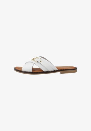Sandalo in pelle bianca con fasce incrociate, dettagli in metallo dorato, suola piatta marrone e cuciture decorative lungo i bordi.