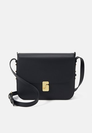 Black leather crossbody bag with a flap, gold hardware clasp, and adjustable strap. Smooth texture with minimalist design and subtle accents.