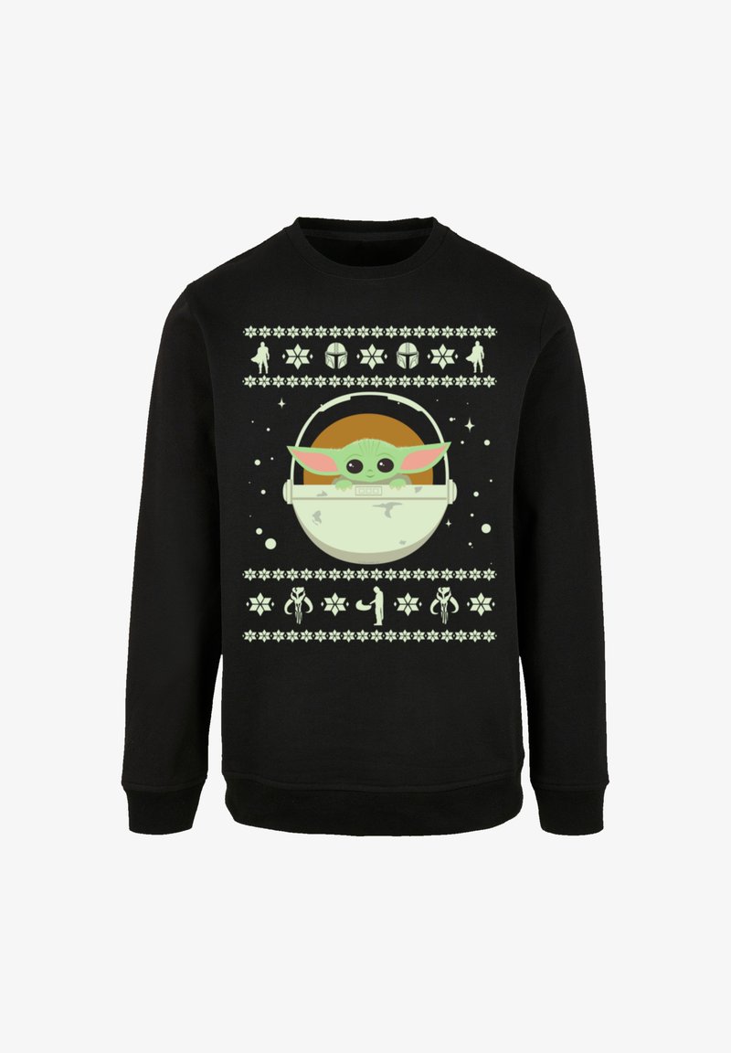 Black sweatshirt featuring a graphic of a green character with large ears in a pod. Design includes star and flower patterns in light colors.