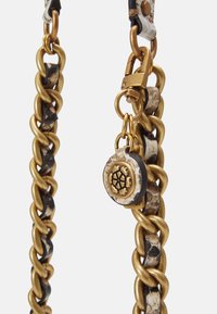 La tracolla in catena d'oro presenta un mix di texture con accenti neri lucidi e un ciondolo decorativo con un design intricato. Inclusi accessori hardware resistenti.