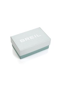 Coperchio d'argento con finitura testurizzata e lettering bianco "BREIL"; base teal. Forma rettangolare, superfici lisce con una leggera lucentezza.