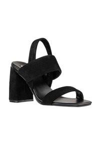 Sandali neri con tacco blocco, caratterizzati da ampie cinghie in suede e un design aperto sulla punta. Il tacco ha una finitura texturizzata ed è elevato.