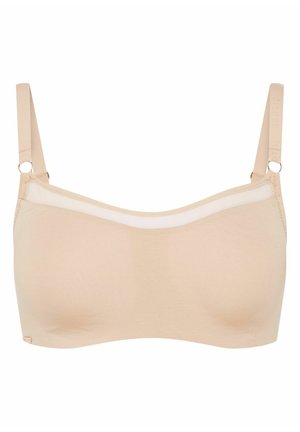 Beżowy bezprzewodowy stanik z miękkiego materiału, przezroczym górnym brzegiem i regulowanymi ramiączkami z okrągłymi elementami metalowymi dla wsparcia i elastyczności.