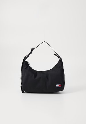 Black nylon shoulder bag with a curved shape, adjustable strap, zipper closure, and a small logo patch in red, white, and blue.
