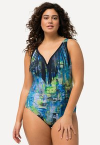 Eén stuk badpak met een meerkleurig abstract patroon in blauw en groen, voorzien van een V-halslijn en zwarte franjeranden op de borst.