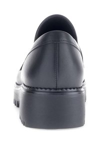Zwarte leren schoenen met een ronde hak, een gladde textuur en gedetailleerde stiksels langs de achternaad. Lege zool met een geribbeld patroon.