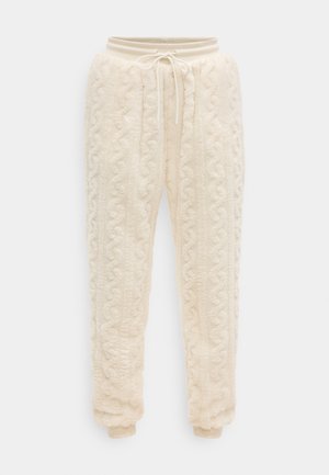 Pantaloni jogger din fleece de culoare crem, cu model tricotat în coz de cablu, talie cu bandă elastică și șnur reglabil, precum și buzunare elastice la glezne.