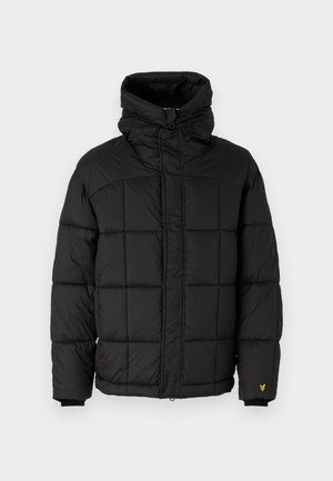 Black puffer jacket with a high collar, quilted design, zip closure, and black ribbed cuffs. Features a small yellow logo on the sleeve.