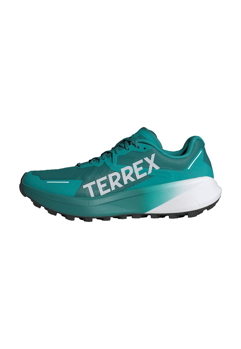 Scarpa da atletica turchese con tomaia in rete, suola nera e branding "TERREX" ben visibile. Presenta una morbida intersuola bianca e dettagli texturizzati.